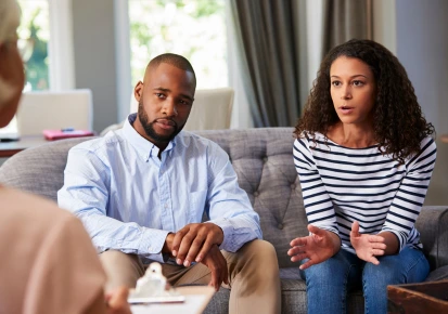 A couple in conversation with a counsellor